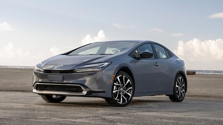 2024 Toyota Prius Prime parked by a body of water.